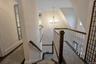 Stairway featuring a chandelier and a high ceiling