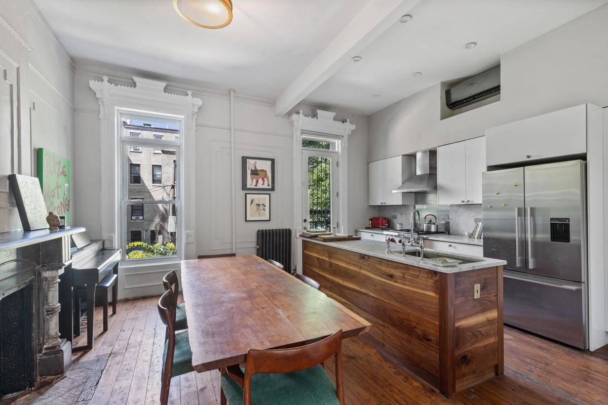 Experience townhouse living in this lovingly restored and renovated with modern amenities duplex dripping in original molding, art nouvelle wood frames, banisters and doors, stone fireplace in each room.