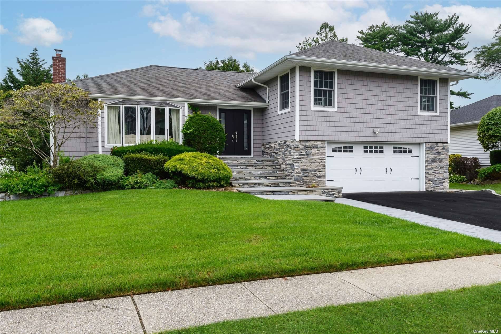 This stunning Split Level home is located in the heart of Syosset and offers an array of luxurious features and upgrades.