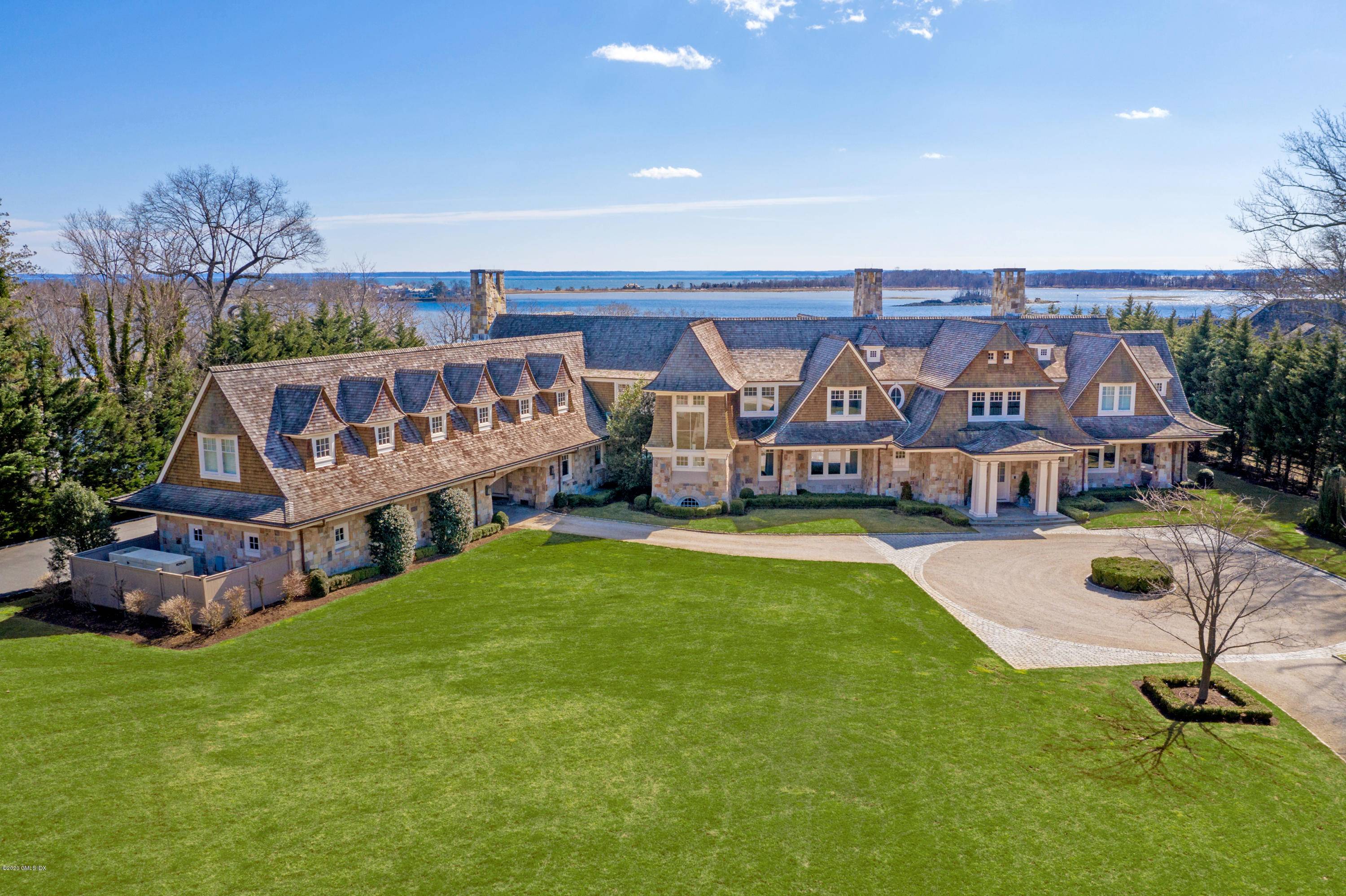 Unparalleled water views from nearly every room in this timeless Shope Reno Wharton shingle and stone waterfront masterpiece with a commanding presence at the end of the revered Meadow Road.