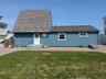View of front of home featuring a front yard and board and batten siding
