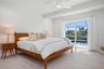 Bedroom 2 with sliding doors to the pool deck