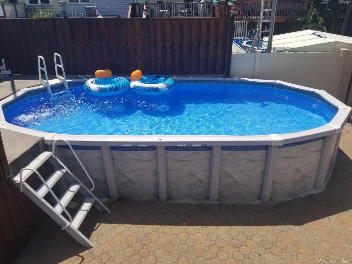 Above ground pool with deck. Refreshing on a hot summers' day!