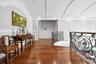 Corridor featuring a decorative wall, dark wood finished floors, and crown molding