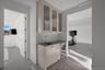 Bar featuring tasteful backsplash, wine cooler, and sink