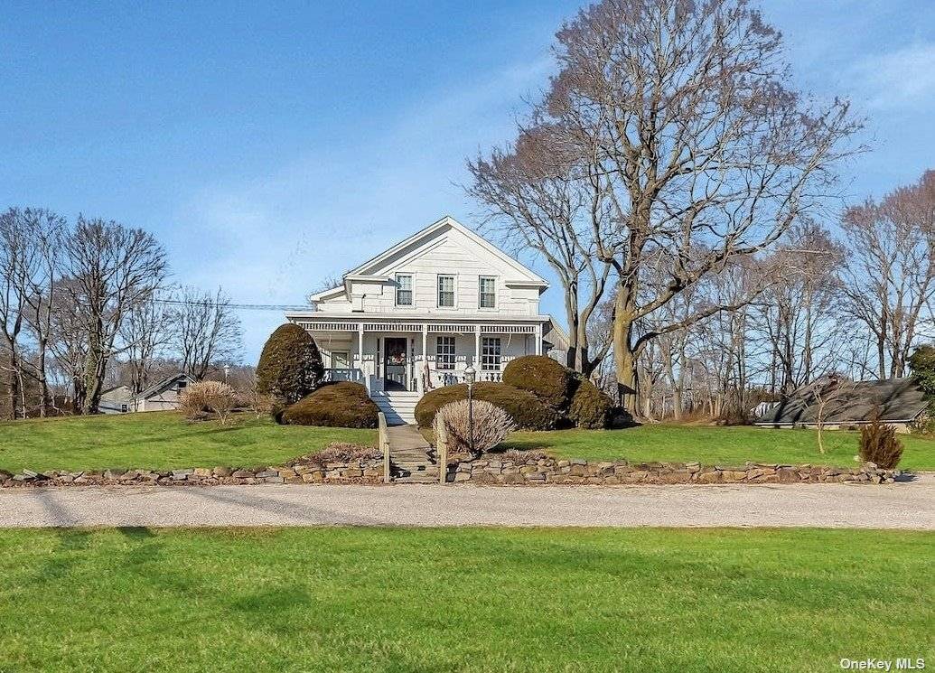 On the corner of Main Road and Tuthills Lane, in the charming Hamlet of Jamesport, the beautiful historic Greek Revival Daniel Tuthill homestead sits high on the hill.