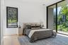 Bedroom with en suite bath, expansive floor to ceiling windows with outdoor access to balcony