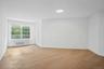 King sized primary bedroom with updated lighting and cozy windowed reading nook with remote controlled motorized shades