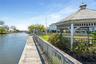 View of dock featuring fence and a water view