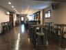 Dining space featuring a drop ceiling, a wall mounted air conditioner, and dark hardwood / wood-style flooring