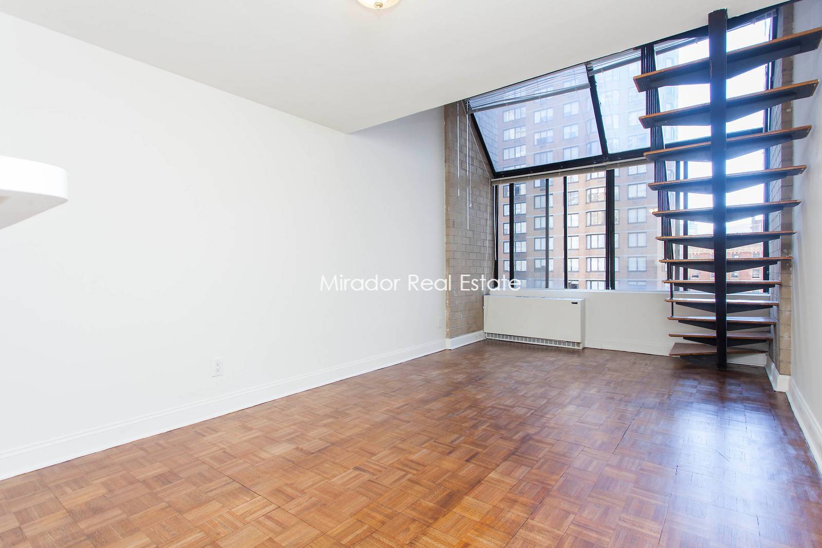 The apartment is a beautiful one bedroom duplex loft in a centrally located 24 hour doorman building in Murray Hill.