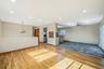 Unfurnished living room featuring light wood-type flooring, ceiling fan, recessed lighting, a chandelier, and a baseboard radiator