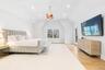 Bedroom with access to exterior, light wood-type flooring, recessed lighting, lofted ceiling, and a chandelier
