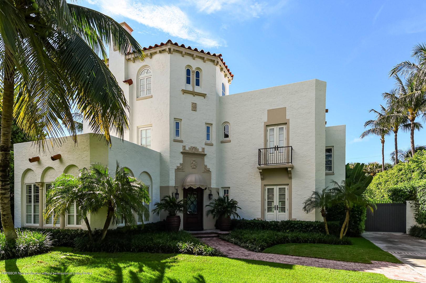 Three story Mediterranean Revival style residence located in town on a coveted ocean block.