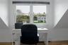 Office area featuring light wood-style floors, plenty of natural light, and a baseboard radiator