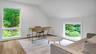 Office space with light hardwood / wood-style flooring and lofted ceiling