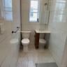 Full bath with vanity, tile walls, tile patterned flooring, and a walk in shower