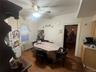 Dining space with dark wood finished floors, radiator heating unit, and a ceiling fan
