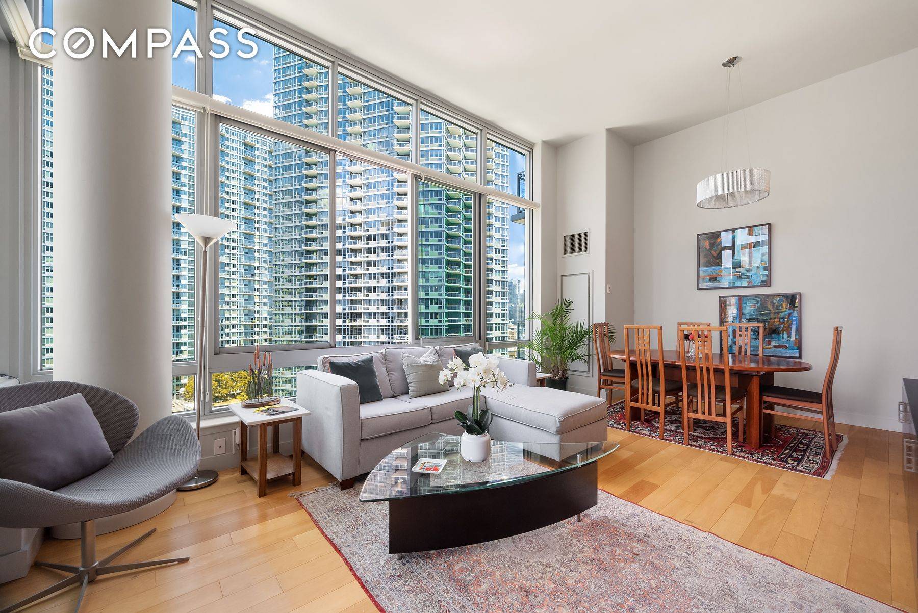 This stunning sun drenched loft like large 1 bed 1 bath home boasts floor to ceiling windows, hardwood floors throughout and a private western facing balcony right off the spacious ...