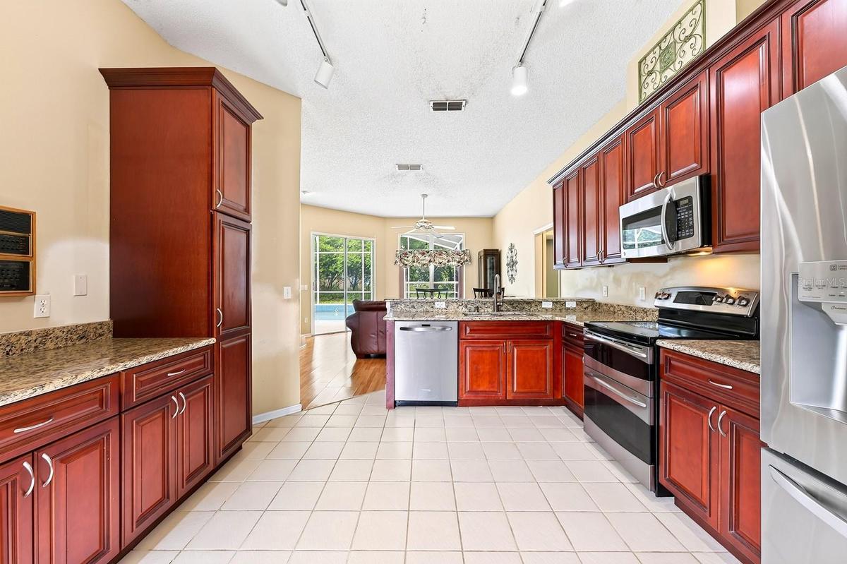 The Kitchen overlooks the Family Room and is ready for the home chef with NEW STAINLESS STEEL APPLIANCES, granite countertops, an abundance of wood ca