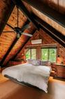 Primary bedroom and lofted ceiling with beams