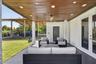 OUTDOOR PATIO WITH CABANA BATH BEHIND DOOR AHEAD