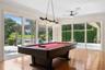 Game area of the GREAT ROOM. Large Sliding doors to open up the fresh air and always the view of the Lake and natural light