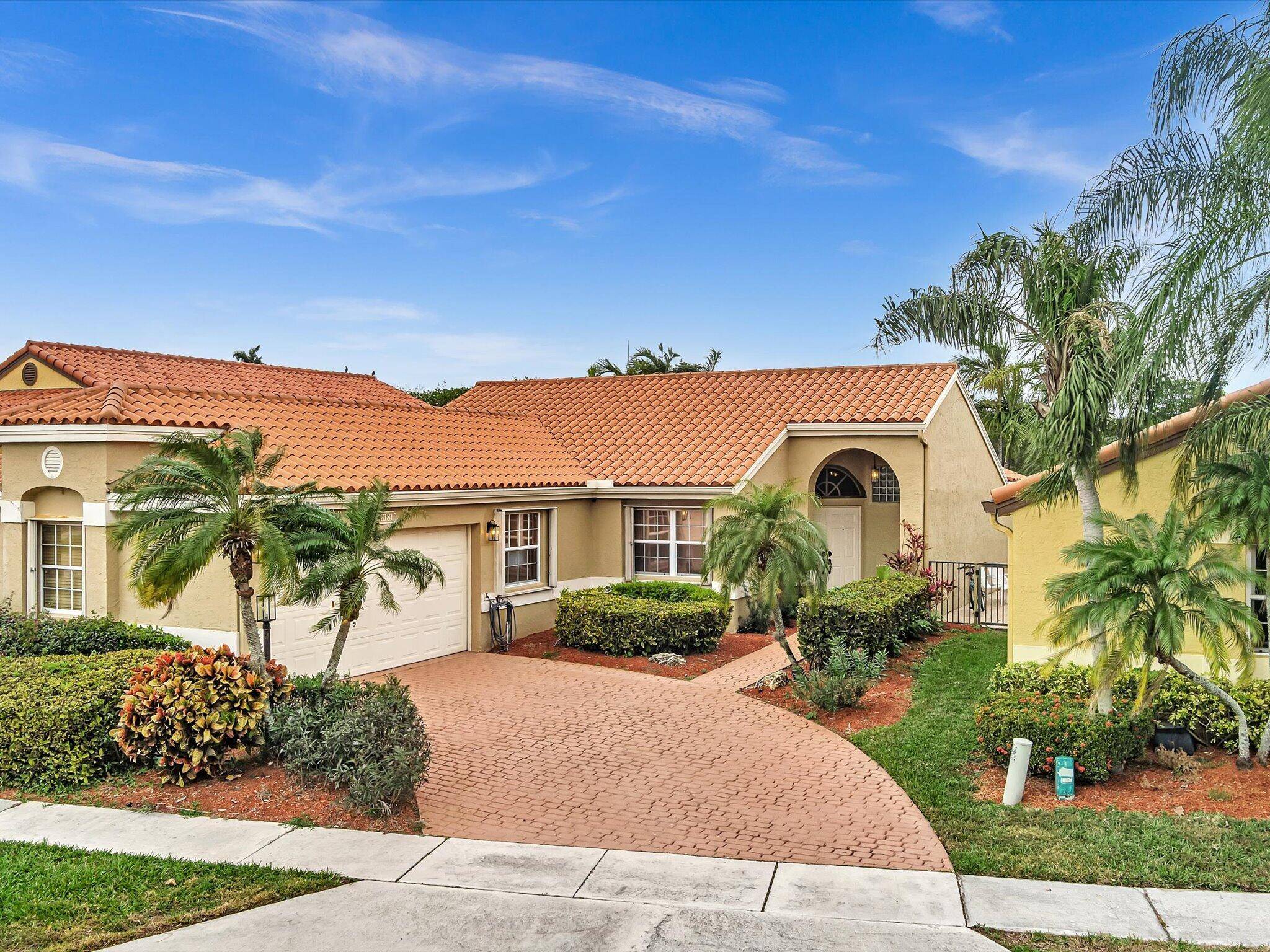 FULLY REMODELED FLOOR CEILING POOL HOUSE IN THE HEART OF BOCA WITH THE LAKE VIEW.