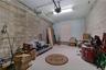 Garage featuring concrete block walls, a light blue painted wall, a white ceiling with track for garage door opener, and a single interior door
