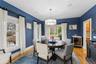 Dining room featuring light wood-style floors, beverage cooler, and a chandelier