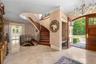 Entryway featuring a chandelier, ornamental molding, french doors, and stairway