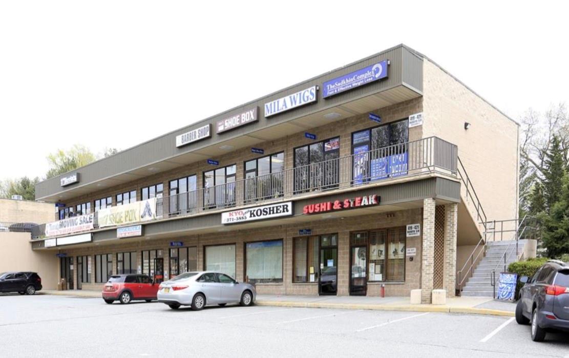 View of commercial location featuring a parking lot