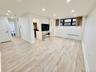 Basement featuring radiator heating unit, recessed lighting, and light wood finished floors