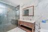Full bath featuring tile walls, double vanity, a shower stall, recessed lighting, and light marble finish flooring