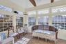 Sunroom with a towering ceiling and tile patterned floors