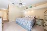 The Primary Suite offers a PEACEFUL RETREAT with its own sliding glass doors opening directly to the patio and pool.