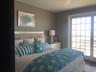 Bedroom with multiple windows, wood finished floors, and a ceiling fan