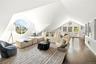 Living room featuring vaulted ceiling and wood finished floors