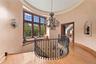 Stairs with wood finished floors, a chandelier, and ornamental molding