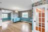 Hardwood flooring throughout featuring floral patterned wallpaper