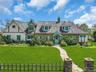 Stone and stucco exterior featuring a prominent teal front dutch door and complementary trim
