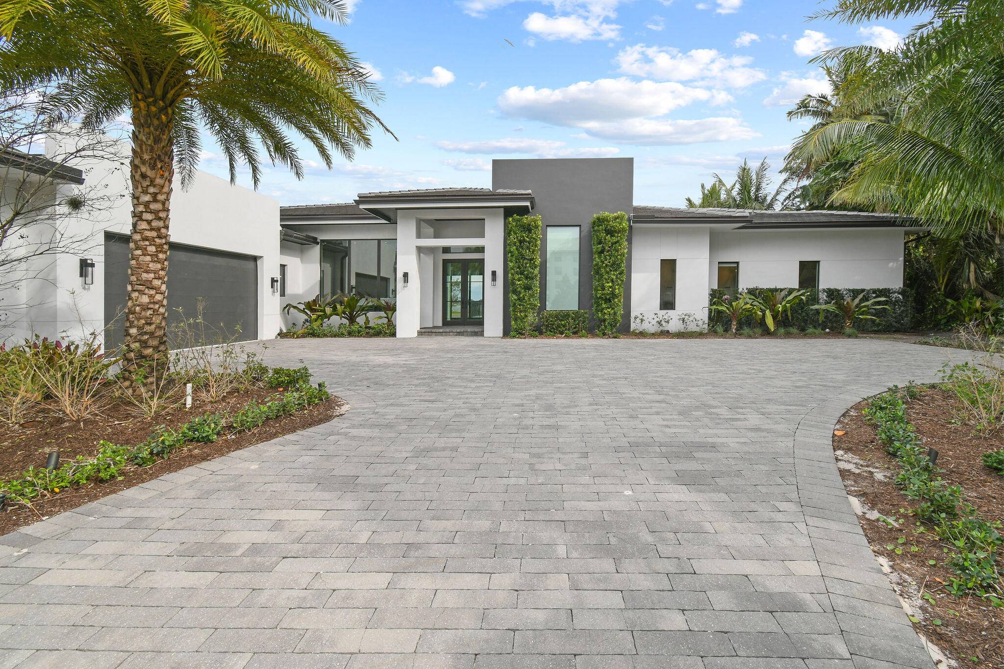 Contemporary waterfront newer construction home in the gated community Presidential Estates.