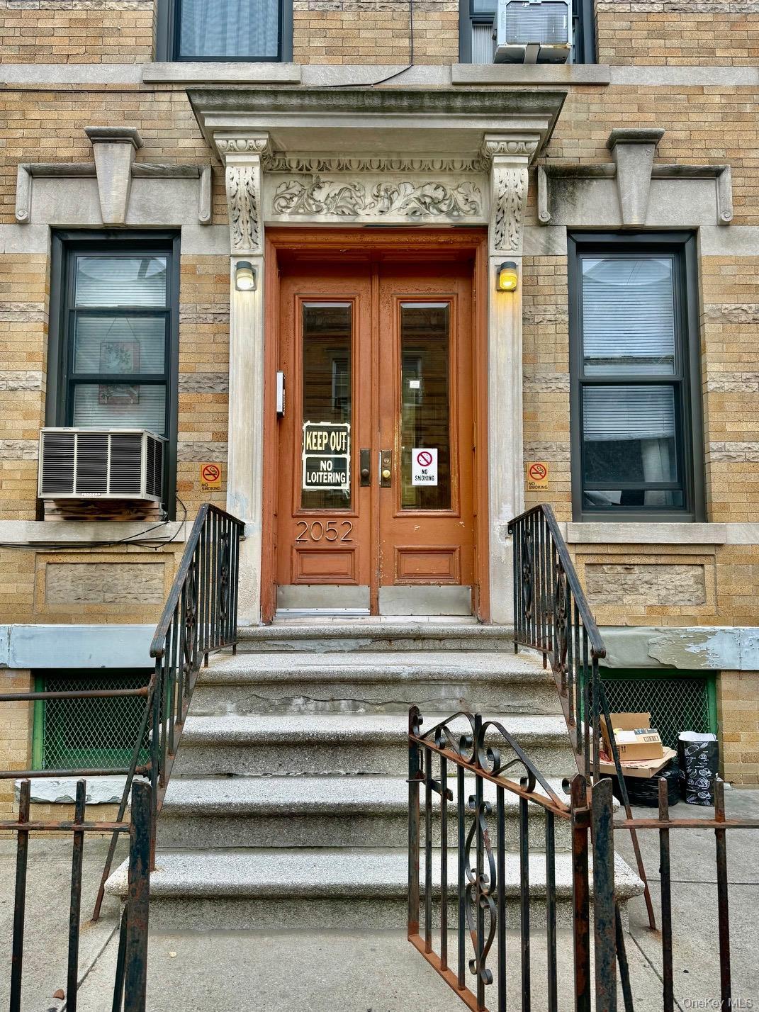 View of exterior entry featuring stone siding, french doors, and brick siding