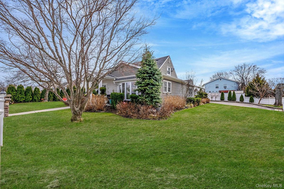 View of property exterior with a yard