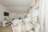 Dining room with plenty of natural light, vaulted ceiling, and light wood-style flooring