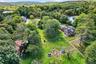 Drone / aerial view of a forest and a nearby body of water