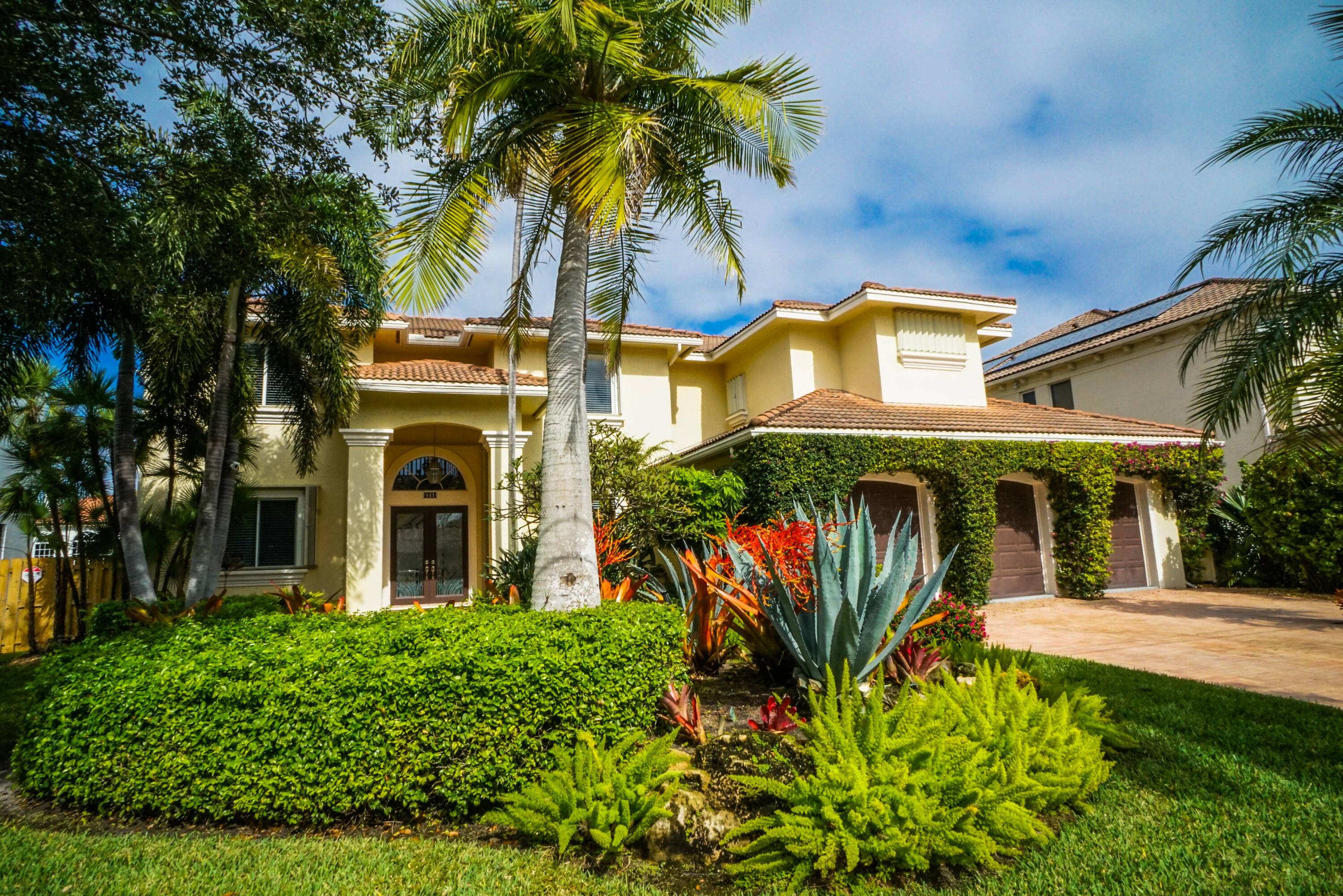 Step into this stunning 4 bedroom, 4 bath home with a 3 car garage offered as a furnished annual rental in Tropic Isle, the exclusive waterfront community in Delray Beach.