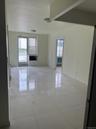 Empty room with plenty of natural light, light tile patterned flooring, and baseboards