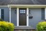 Property entrance featuring roof with shingles