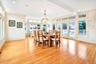 Huge Dining area with healthy amount of natural light, light wood-type flooring, a chandelier, and recessed lighting. Doors out to very large deck.
